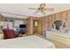 Spacious bedroom with wood paneled walls, ceiling fan, and ensuite bathroom at 698 & West W Perry St, Englewood, FL 34223