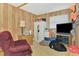 Bedroom features a comfortable armchair and entertainment center with mounted TV at 698 & West W Perry St, Englewood, FL 34223