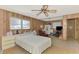 Bedroom with wood paneled walls, ceiling fan, and natural light from windows at 698 & West W Perry St, Englewood, FL 34223