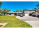 Charming two-story home featuring an oversized driveway, two-car garage, and parking for your RV at 698 & West W Perry St, Englewood, FL 34223