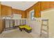 Remodeled kitchen with exposed wall studs and yellow-toned cabinets, awaiting personalized renovation touches at 698 & West W Perry St, Englewood, FL 34223