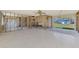 Spacious, partially remodeled living area, exposed framing, and yard views awaiting stylish personalization at 698 & West W Perry St, Englewood, FL 34223