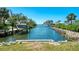 Picturesque canal view featuring a boat lift, lush greenery, and beautiful waterfront vistas at 698 & West W Perry St, Englewood, FL 34223
