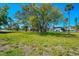 Spacious yard with mature trees creating a serene setting and ample space for outdoor enjoyment at 698 & West W Perry St, Englewood, FL 34223