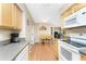 Bright kitchen features wood cabinets, granite counters, and stainless steel appliances with adjacent dining area at 7019 Janette St, Englewood, FL 34224
