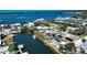 Aerial view of waterfront homes, showcasing a pool, solar panels, and boat access at 741 W Perry St, Englewood, FL 34223