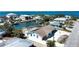 Aerial view showcases canal-front homes, featuring screened pool and a picturesque coastal community at 741 W Perry St, Englewood, FL 34223