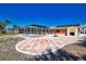 The large backyard patio with colorful accents and a beautiful screen room, perfect for entertaining at 741 W Perry St, Englewood, FL 34223