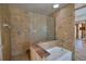 Tiled bathroom featuring a tub, glass shower wall, and decorative granite accents at 741 W Perry St, Englewood, FL 34223