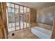 In-progress bathroom featuring a tile wall surround and a bathtub at 741 W Perry St, Englewood, FL 34223