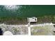 Private wooden dock on a canal surrounded by tropical vegetation at 741 W Perry St, Englewood, FL 34223