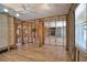 Large living area featuring unfinished walls, wood-look flooring, and abundant natural light at 741 W Perry St, Englewood, FL 34223
