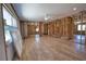 Spacious living area featuring wood-look flooring, ceiling fan, and ample natural light at 741 W Perry St, Englewood, FL 34223