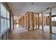 Open-concept living space with unfinished walls, wood-look flooring, and ample natural light at 741 W Perry St, Englewood, FL 34223