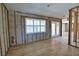 Living area featuring wood-look flooring, window shutters, and access to outdoor patio at 741 W Perry St, Englewood, FL 34223