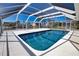 Screened-in pool with crystal clear water overlooking a picturesque waterfront view at 741 W Perry St, Englewood, FL 34223