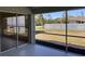 Screened back porch with views of the backyard and white picket fence, providing an inviting outdoor living area at 7499 Clearwater St, Englewood, FL 34224