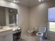 Spacious bathroom with vanity, commode and bidet, plus a large mirror, and a bright window at 7499 Clearwater St, Englewood, FL 34224