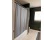 Cozy bathroom featuring a shower with a gray curtain and a window that provides natural lighting at 7499 Clearwater St, Englewood, FL 34224
