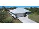 Charming one-story home with a new metal roof, attached two-car garage, and well-manicured landscaping at 7499 Clearwater St, Englewood, FL 34224