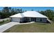 Beautiful single-story home featuring a modern metal roof, well-maintained lawn, and an attached two-car garage at 7499 Clearwater St, Englewood, FL 34224