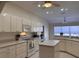 Bright kitchen features white cabinetry, modern appliances, and a center island, perfect for meal prep and casual dining at 7499 Clearwater St, Englewood, FL 34224