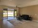 Inviting living room with sliding glass doors to the lanai and comfortable seating at 7499 Clearwater St, Englewood, FL 34224