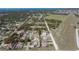 Bird's eye view showing the property outlined in red, set within a residential area close to a large open field at 820 Bayshore Dr, Englewood, FL 34223