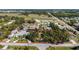 Overhead image of the property highlighted by a red boundary, located near a street and bordered by mature trees at 820 Bayshore Dr, Englewood, FL 34223