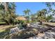 Outdoor entertainment area with lush tropical landscaping and a inviting tiki umbrella at 820 Bayshore Dr, Englewood, FL 34223