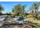 Tropical backyard oasis featuring inviting patio and tiki umbrella at 820 Bayshore Dr, Englewood, FL 34223