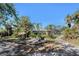 Expansive backyard featuring multiple seating areas and access to an enclosed pool and home at 820 Bayshore Dr, Englewood, FL 34223
