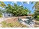 Enjoy the expansive backyard with a detached garage, seating area, and outdoor dining space at 820 Bayshore Dr, Englewood, FL 34223