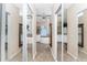 Elegant bathroom with a soaking tub, dual vanities, and mirrored closet doors at 820 Bayshore Dr, Englewood, FL 34223