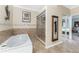 Well-lit bathroom featuring a walk-in shower, a soaking tub, a mirror and tile floor at 820 Bayshore Dr, Englewood, FL 34223