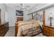 Traditional bedroom with a ceiling fan, grey colored walls and carpet, and a wood bed frame at 820 Bayshore Dr, Englewood, FL 34223