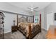 Bedroom with large bed, ceiling fan, and a double-door closet at 820 Bayshore Dr, Englewood, FL 34223