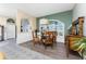 Elegant dining room with stylish furnishings, a round glass-top table, and a large window at 820 Bayshore Dr, Englewood, FL 34223