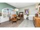 Charming dining area with hardwood floors, large windows, and stylish furnishings at 820 Bayshore Dr, Englewood, FL 34223