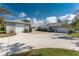 Charming home featuring a spacious driveway and two-car garage with an additional standalone garage at 820 Bayshore Dr, Englewood, FL 34223