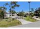 Beautiful property with manicured lawn, gated entrance, mature trees, and a detached garage at 820 Bayshore Dr, Englewood, FL 34223
