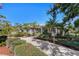 Charming home featuring a long driveway, mature palm trees, and lush landscaping that enhances its curb appeal at 820 Bayshore Dr, Englewood, FL 34223