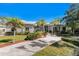 Charming single-story home boasts lush landscaping, mature palm trees, and an inviting entryway at 820 Bayshore Dr, Englewood, FL 34223