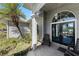 Charming front porch with seating and a decorative pendant light offering a cozy welcome at 820 Bayshore Dr, Englewood, FL 34223