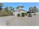 Detached garage showing golf cart and landscaping, offering secure parking and extra storage with a well kept exterior at 820 Bayshore Dr, Englewood, FL 34223