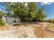 View of large, detached garage with a spacious driveway, offering ample parking and storage at 820 Bayshore Dr, Englewood, FL 34223