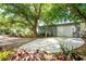Detached garage with a modern design and spacious parking, complemented by well-maintained landscaping at 820 Bayshore Dr, Englewood, FL 34223