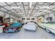 Inside a spacious garage featuring multiple classic cars and ample storage, perfect for collectors and enthusiasts at 820 Bayshore Dr, Englewood, FL 34223