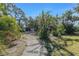 View of detached garage, surrounded by lush greenery, offering ample space and privacy on the property at 820 Bayshore Dr, Englewood, FL 34223
