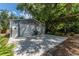 Spacious detached two-car garage with ample parking and storage space, set against a backdrop of trees at 820 Bayshore Dr, Englewood, FL 34223